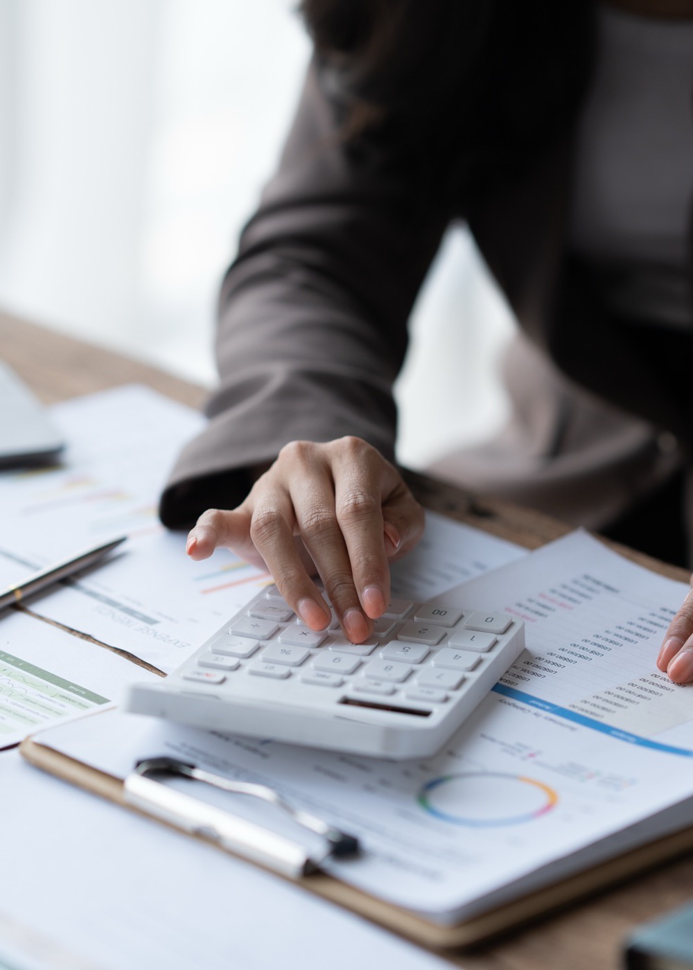 Accountant reviewing financial reports with a calculator